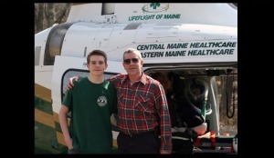 Paul and his son in fron of a Lifeflight helicopter
